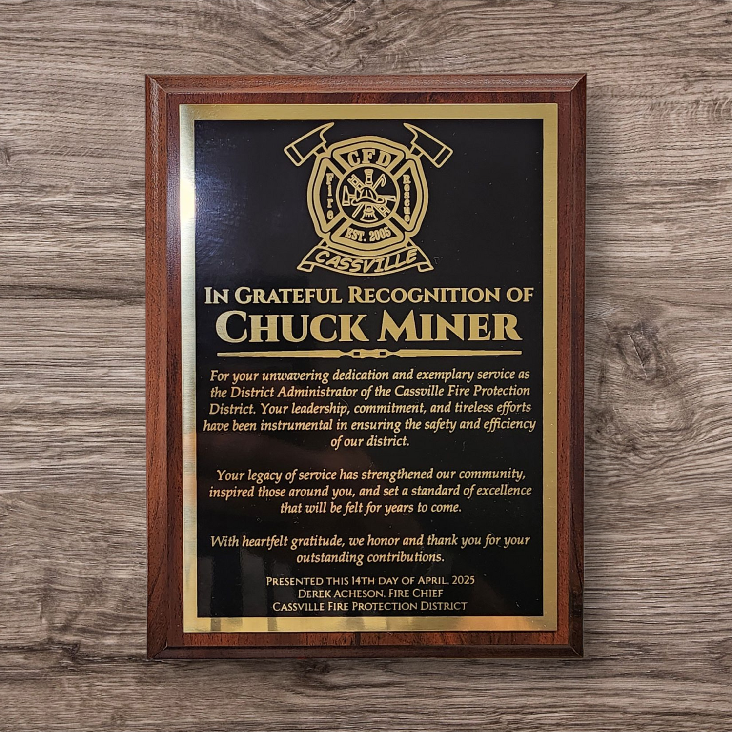Honorary plaque recognizing Chuck Miner for dedication and service at Cassville Fire Protection District