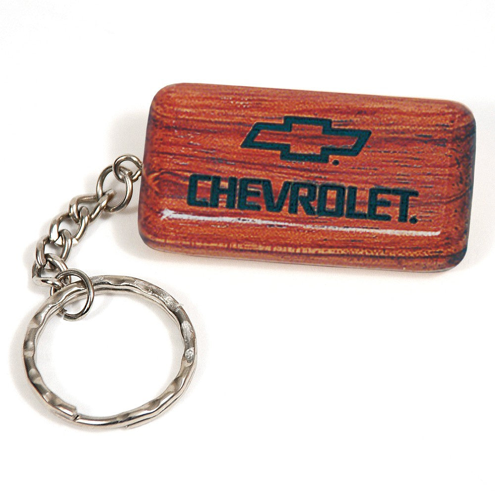 Wooden Chevrolet keychain with engraved logo and metal chain on white background